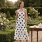 Elegante vestido palabra de honor con volantes y estampado de lunares